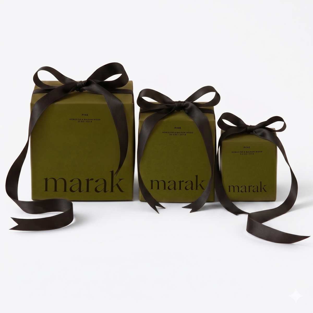 Three green marak candles wrapped with dark ribbon bows