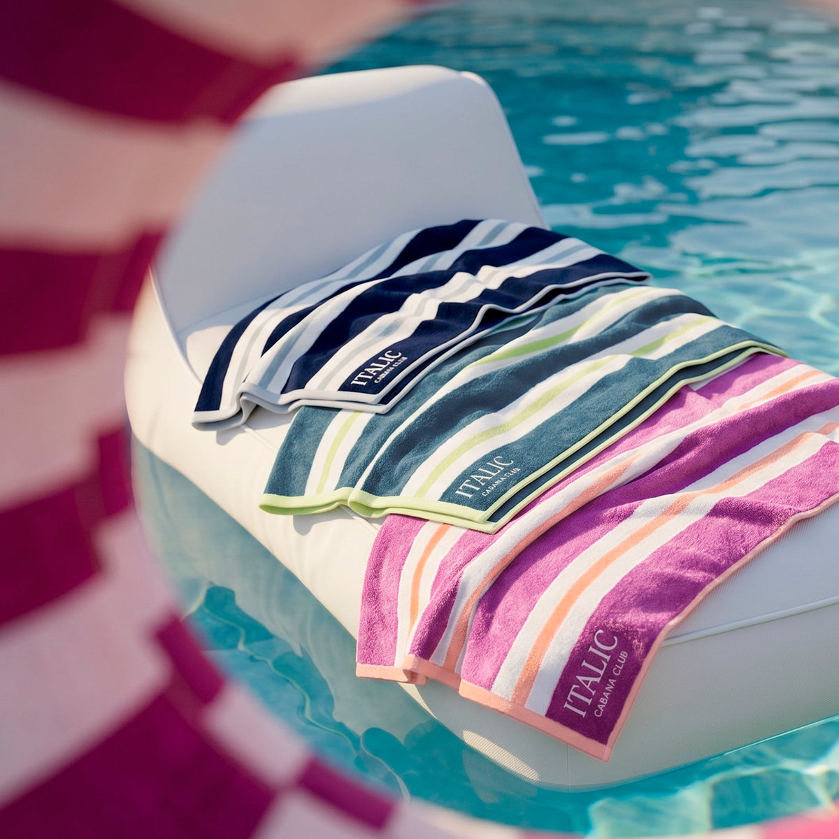 Folded striped cotton towel with navy, white, green, and pink sections