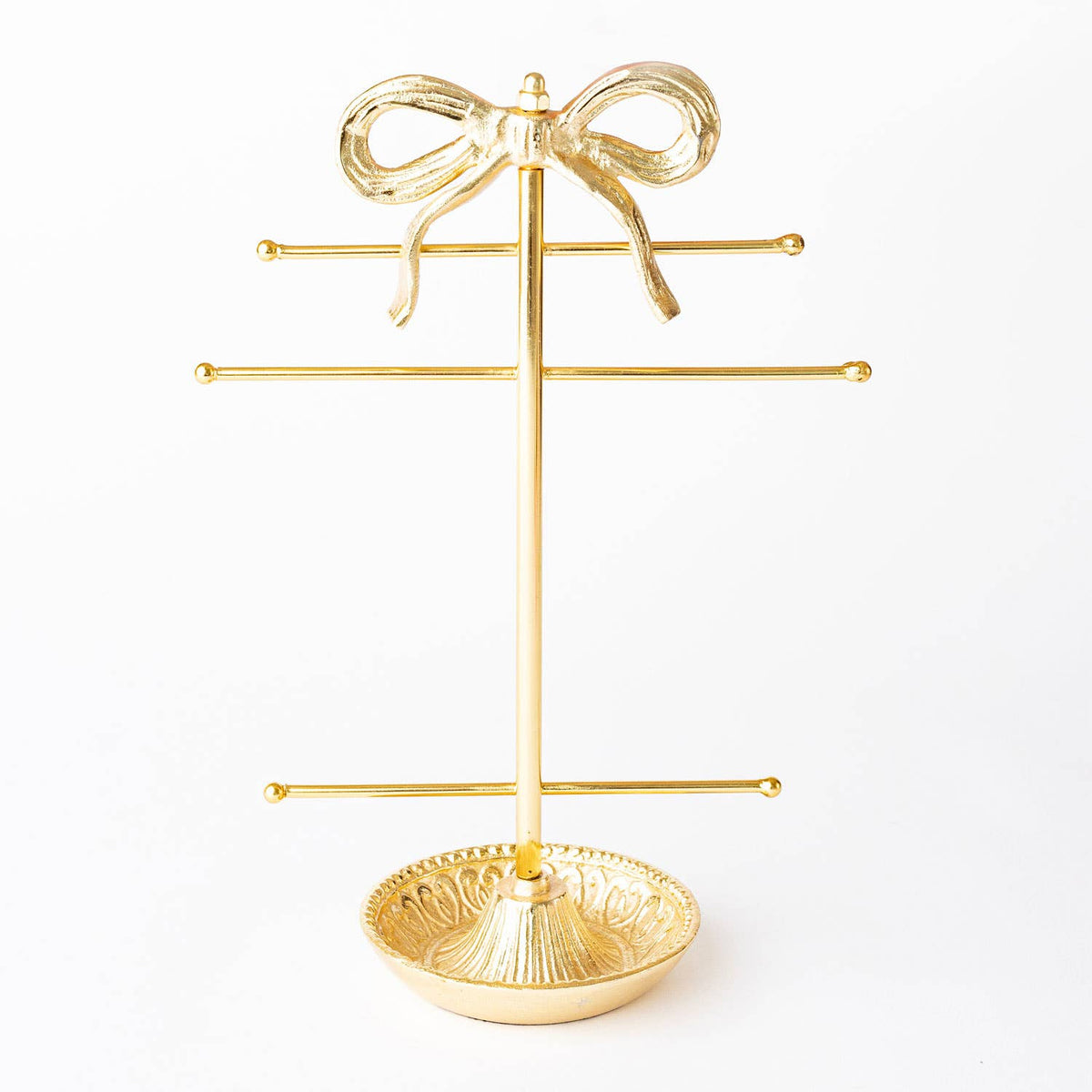 Gold-tone bow jewelry holder with three horizontal bars and round base tray