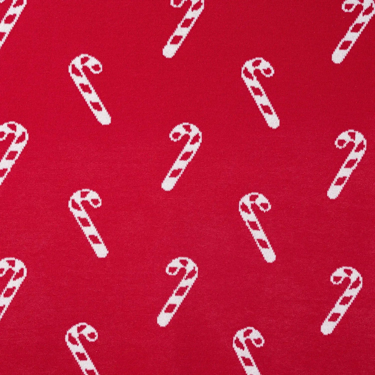 Red knit fabric with small white candy cane motifs, jacquard texture