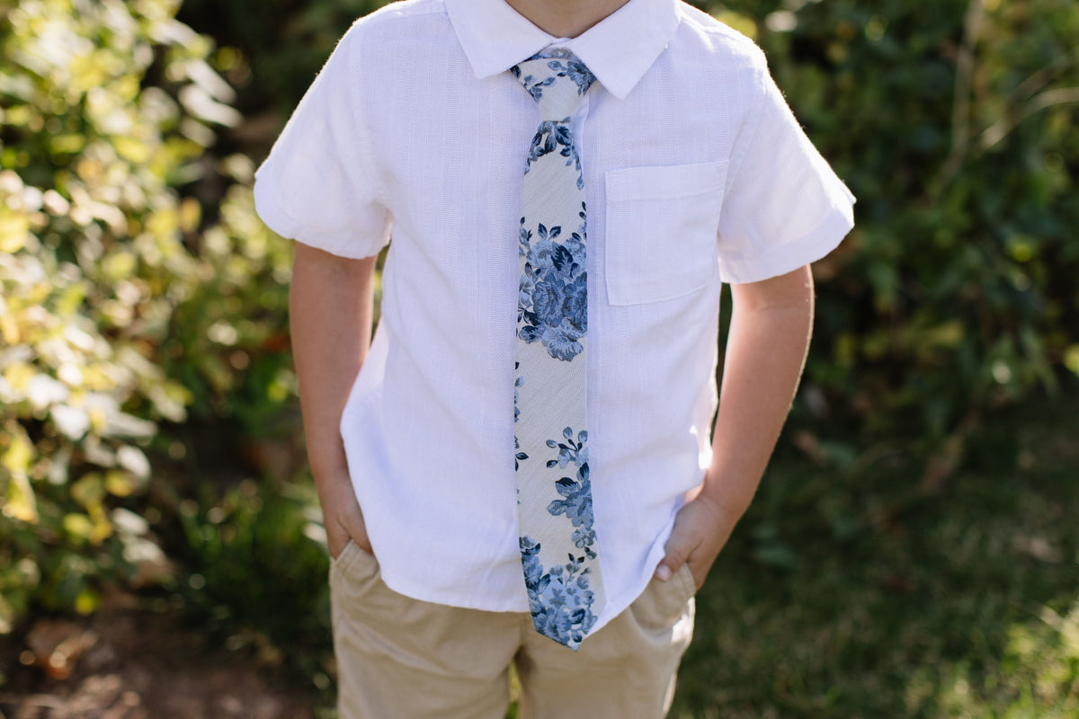 Blue floral necktie with narrow width and leaf pattern