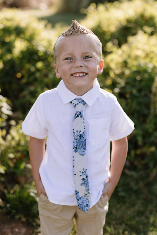 Boys blue floral necktie on white shirt with leaf print