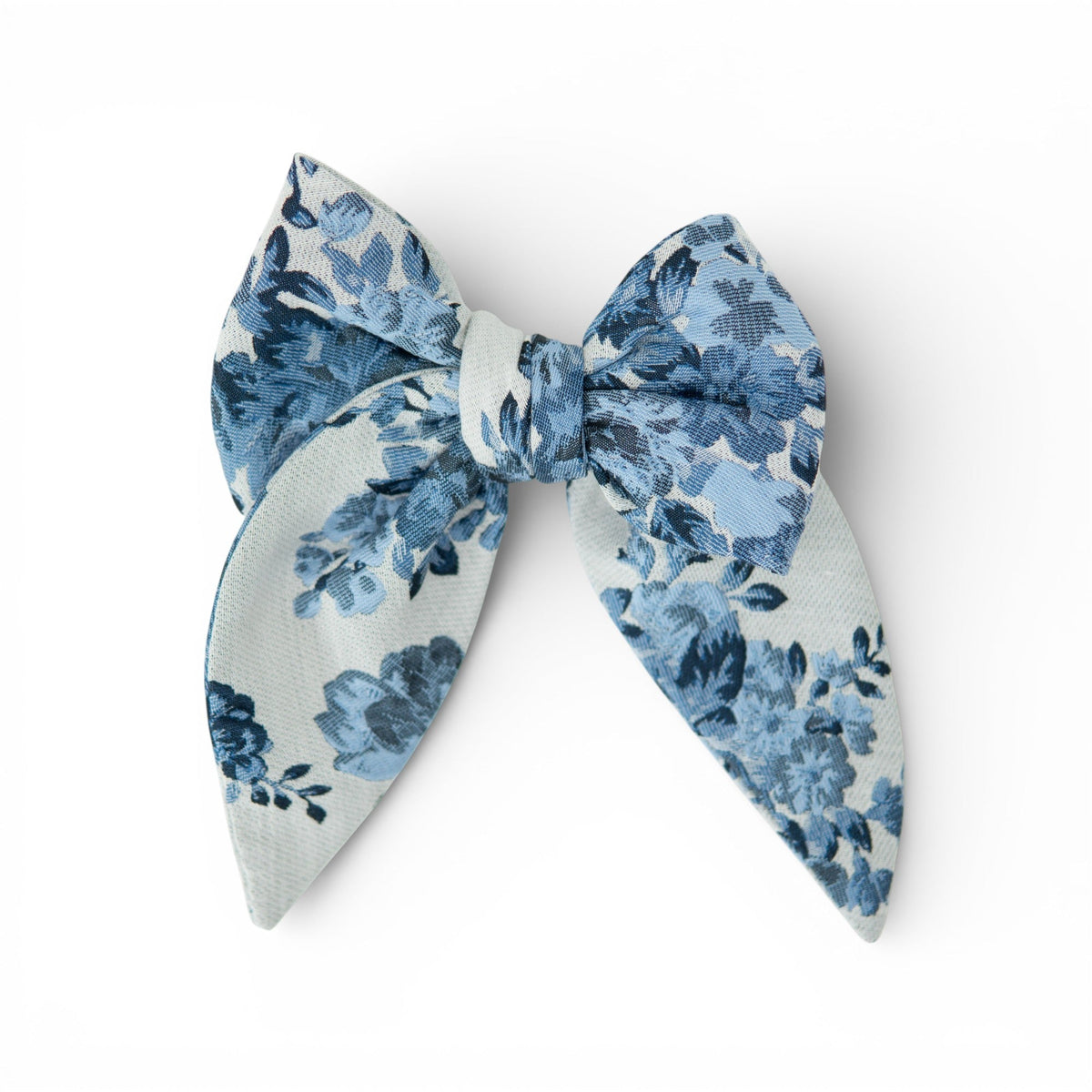 Blue floral fabric hair bow with layered tails and center knot