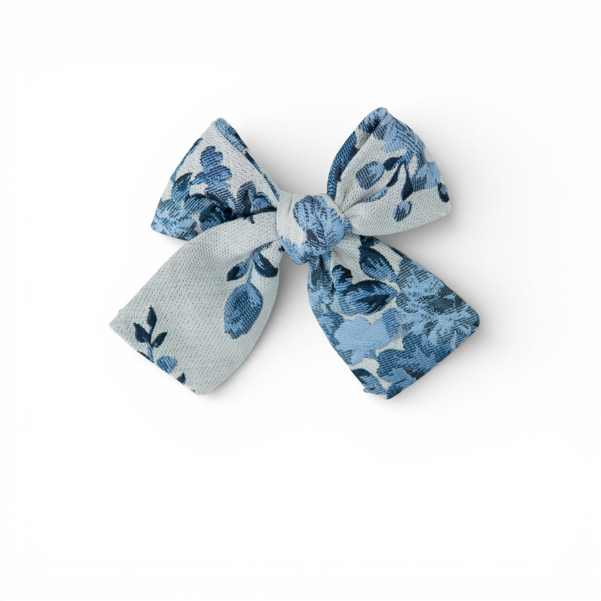 Petite hair bow in light blue and navy floral print, tied bow shape