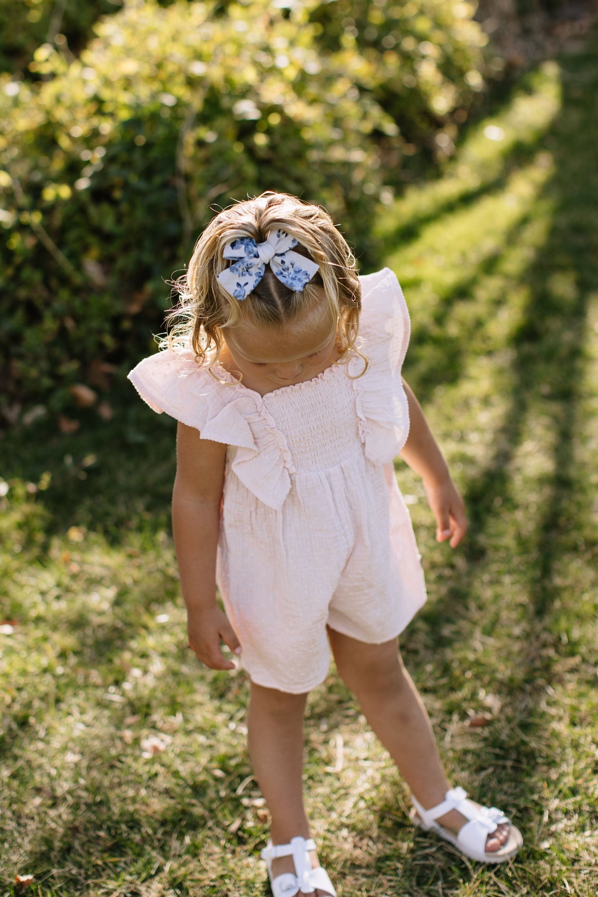 Blue floral petite hair bow worn in hair, bow knot centered