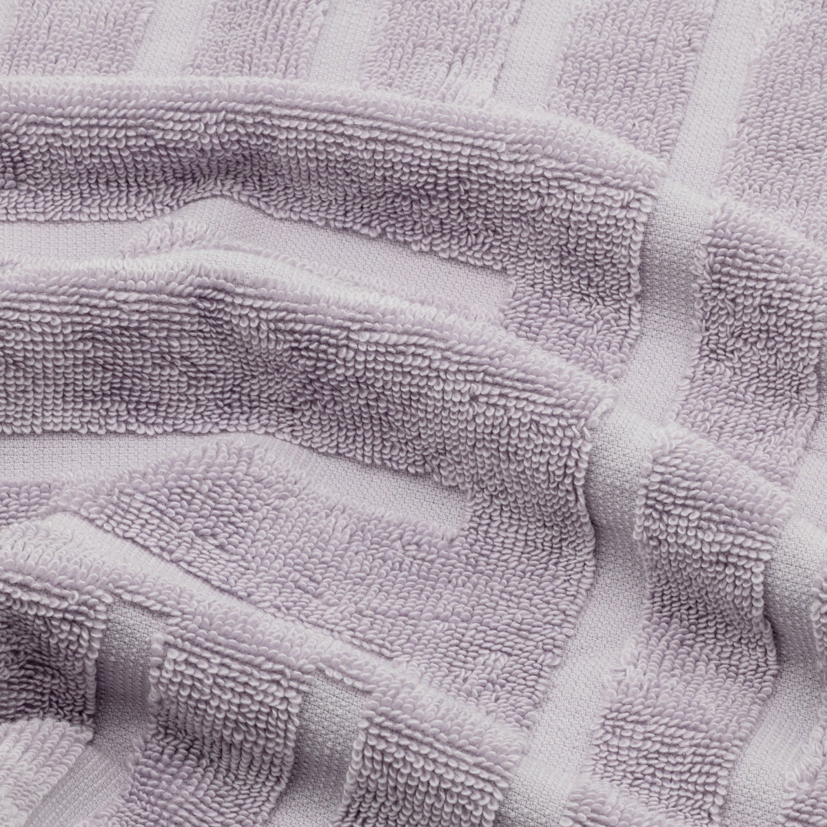 Lilac cotton towel detail with terry loops and stitched geometric pattern