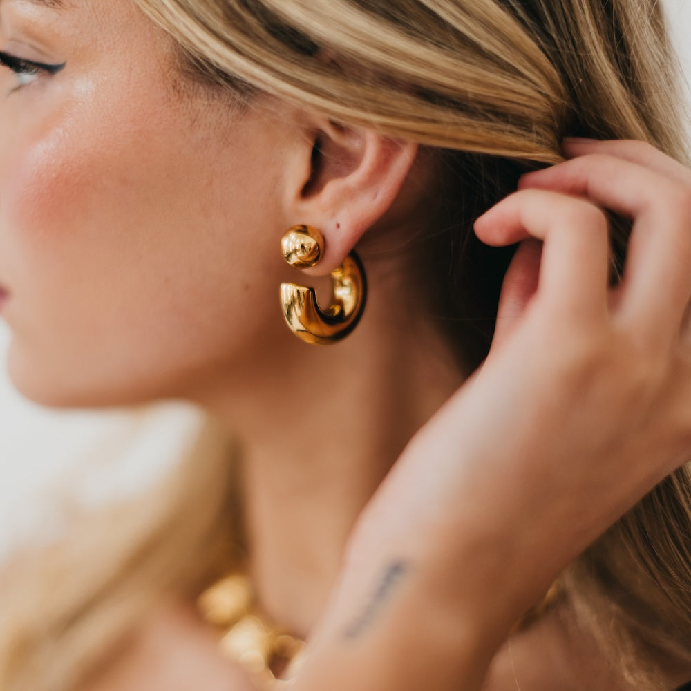 Gold reversible hoop earrings with chunky double-hoop design and ball detail