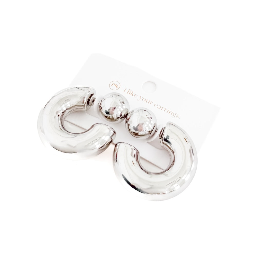 Silver reversible hoop earrings, glossy double-hoop shape with small ball accents