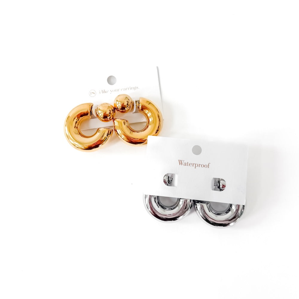 Gold and silver reversible waterproof hoop earrings on display card