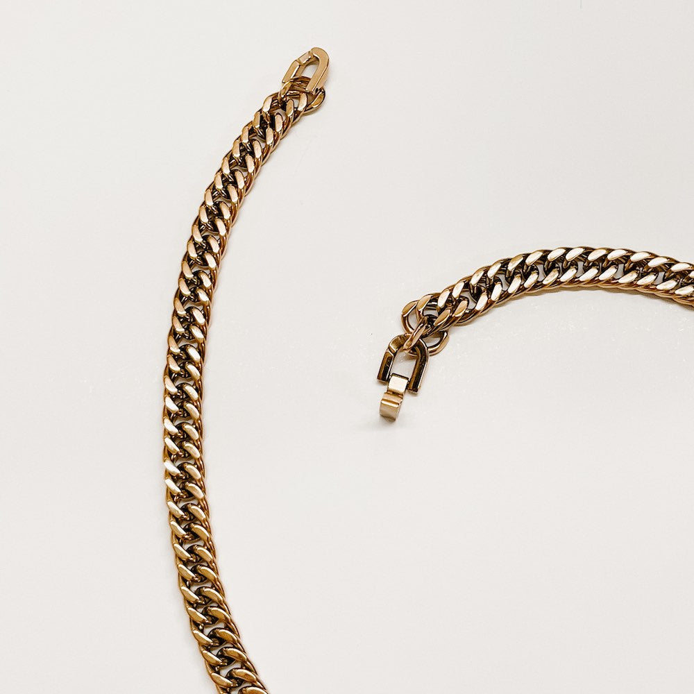 Gold Cuban chain necklace close-up, interlinked links and small clasp hardware