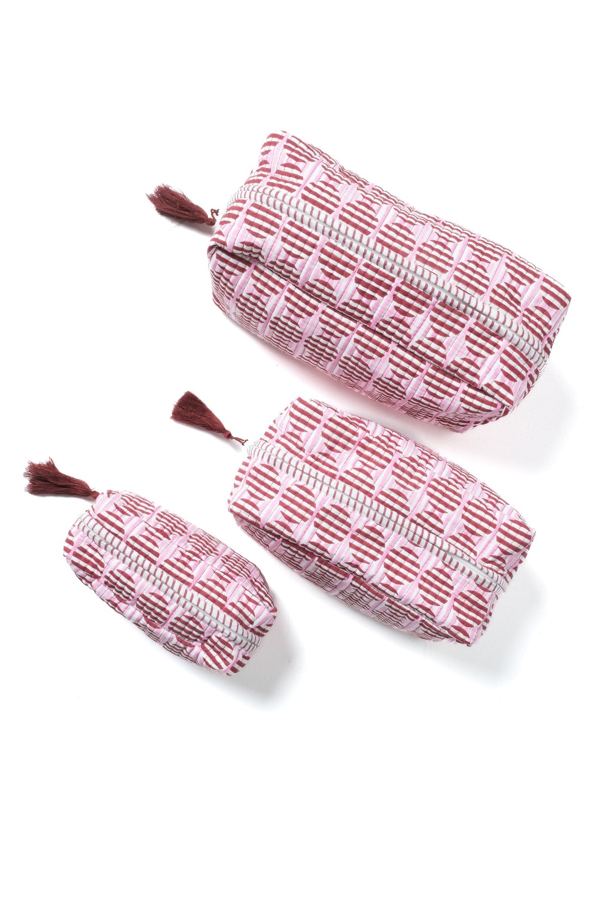 Striped blockprint makeup pouches in burgundy and pink, each with tassel