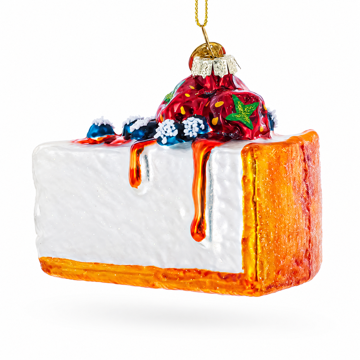 Glass cheesecake ornament side view with red berries, blue crumb, and orange dripping glaze