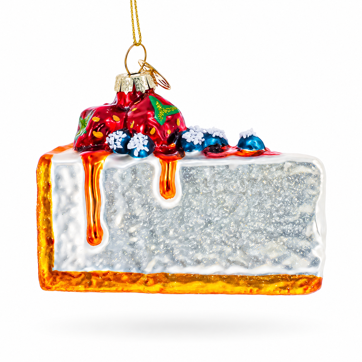 Front view glass cheesecake ornament with white frosting, red berries, blue crumb, glittery base