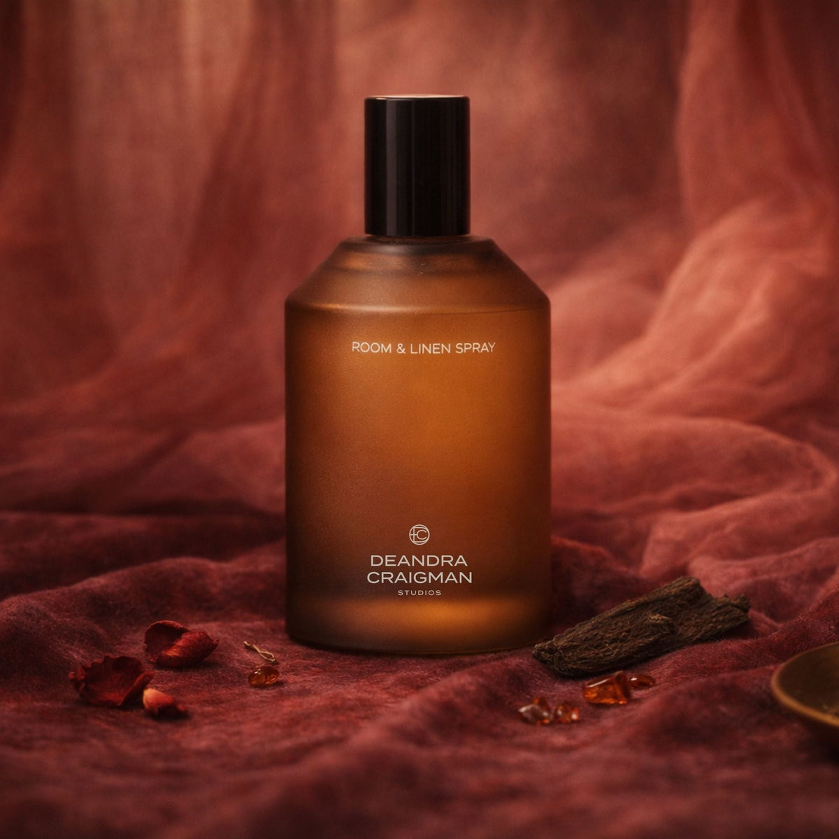 Amber room and linen spray bottle with black spray cap, front label visible