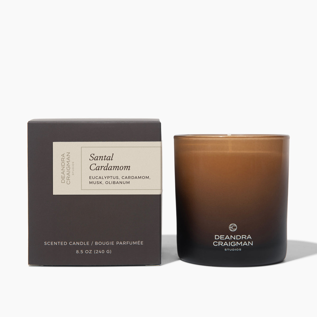 Scented candle in amber glass jar with black base and coordinating box