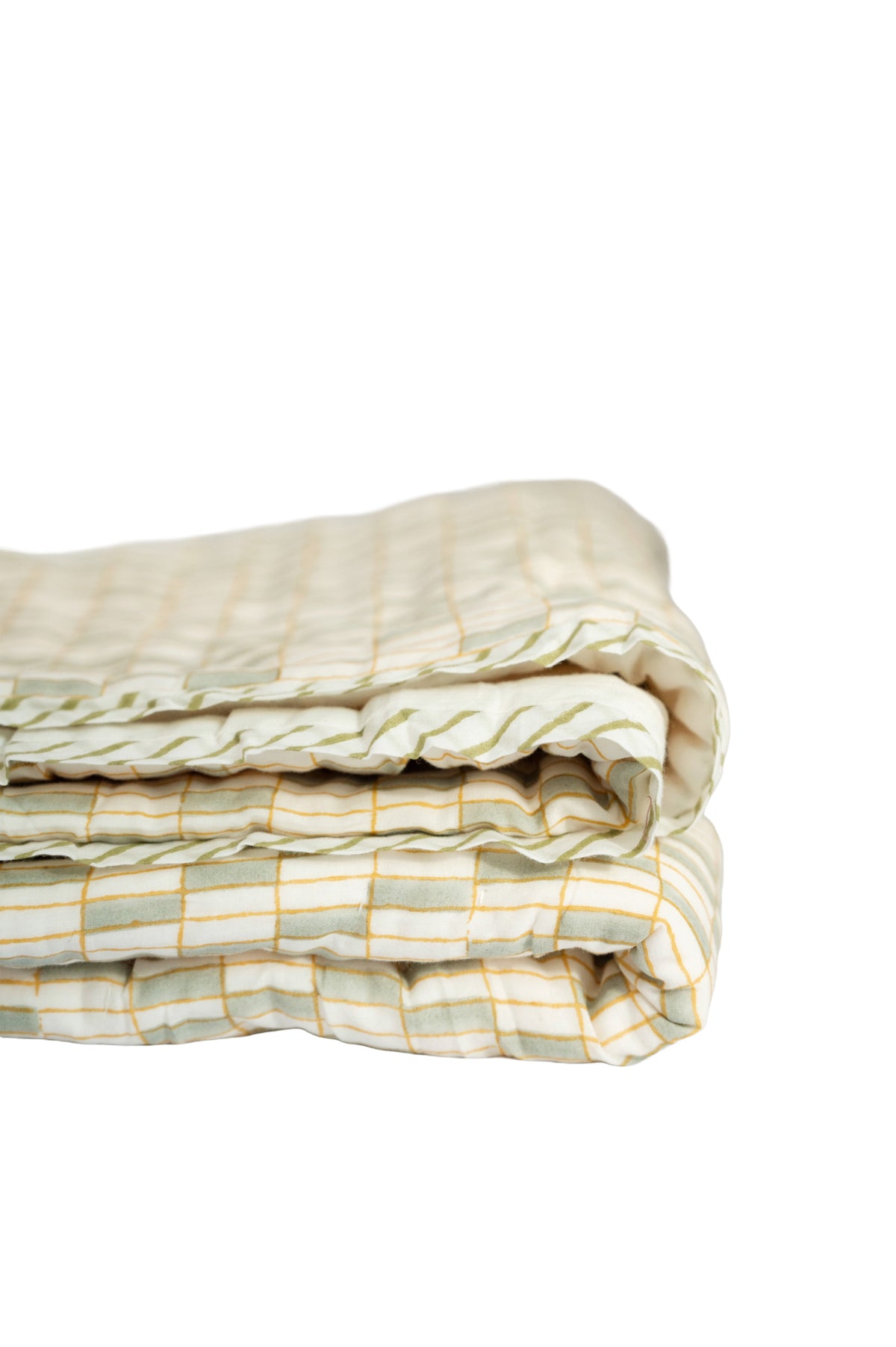 Folded patchwork quilt with green-and-white stripes and thin yellow grid lines