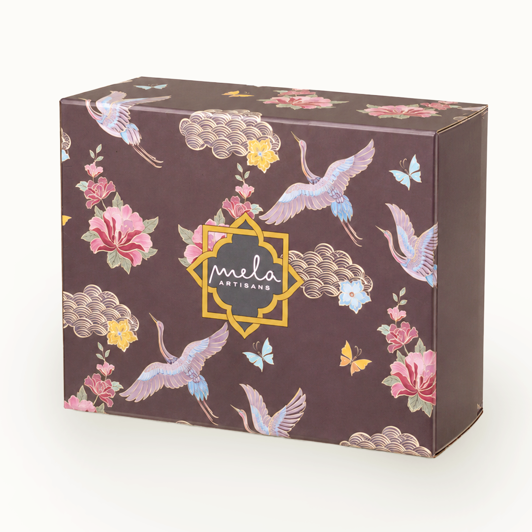 Large decorative gift box in dark brown with floral, cranes, and “mela artisans” logo