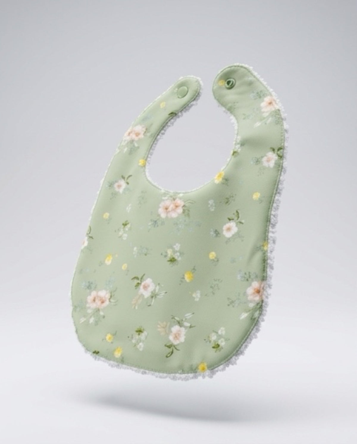 Infant linen bib in sage green with floral sprigs and round snap at top