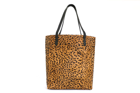 Leopard print tote bag with black top handles and rectangular shape.