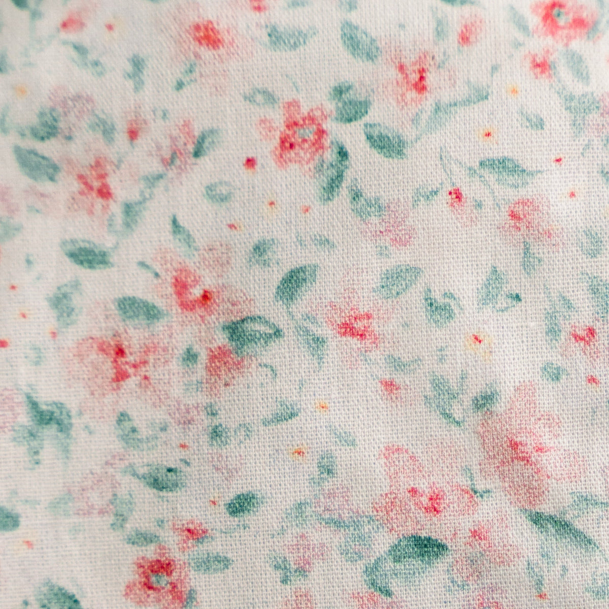 Pastel floral confetti fabric swatch with multicolor print on light base