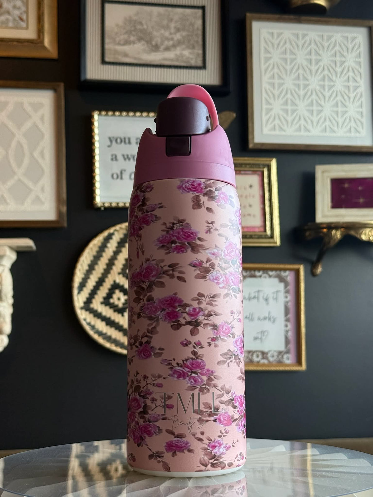 Light pink floral insulated bottle with black flip-top lid