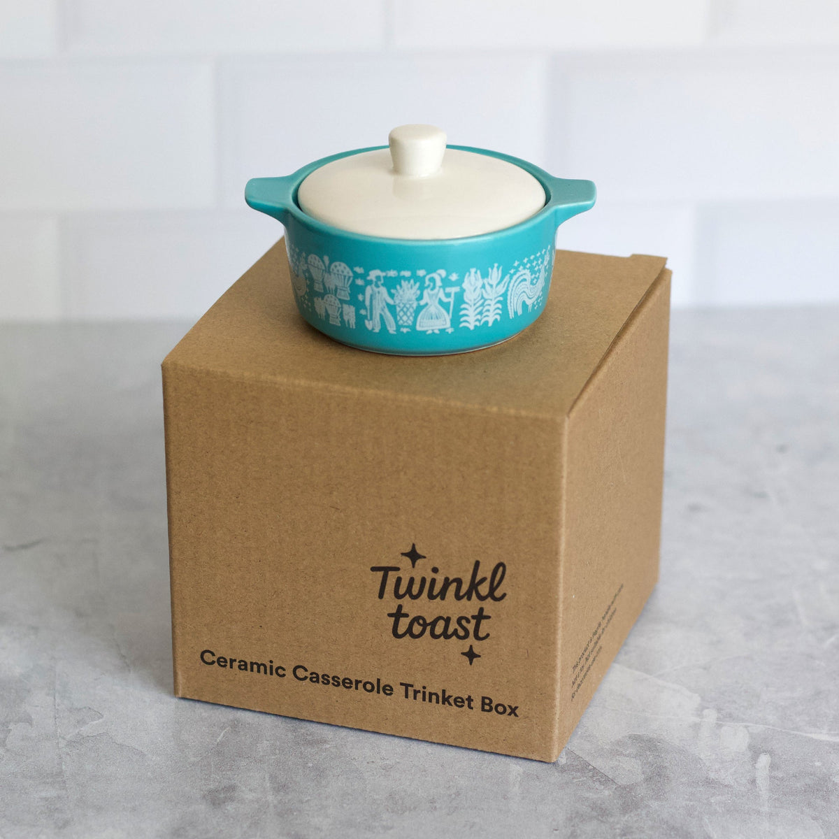 Blue ceramic casserole trinket box with white lid on a Twinkle Toast box