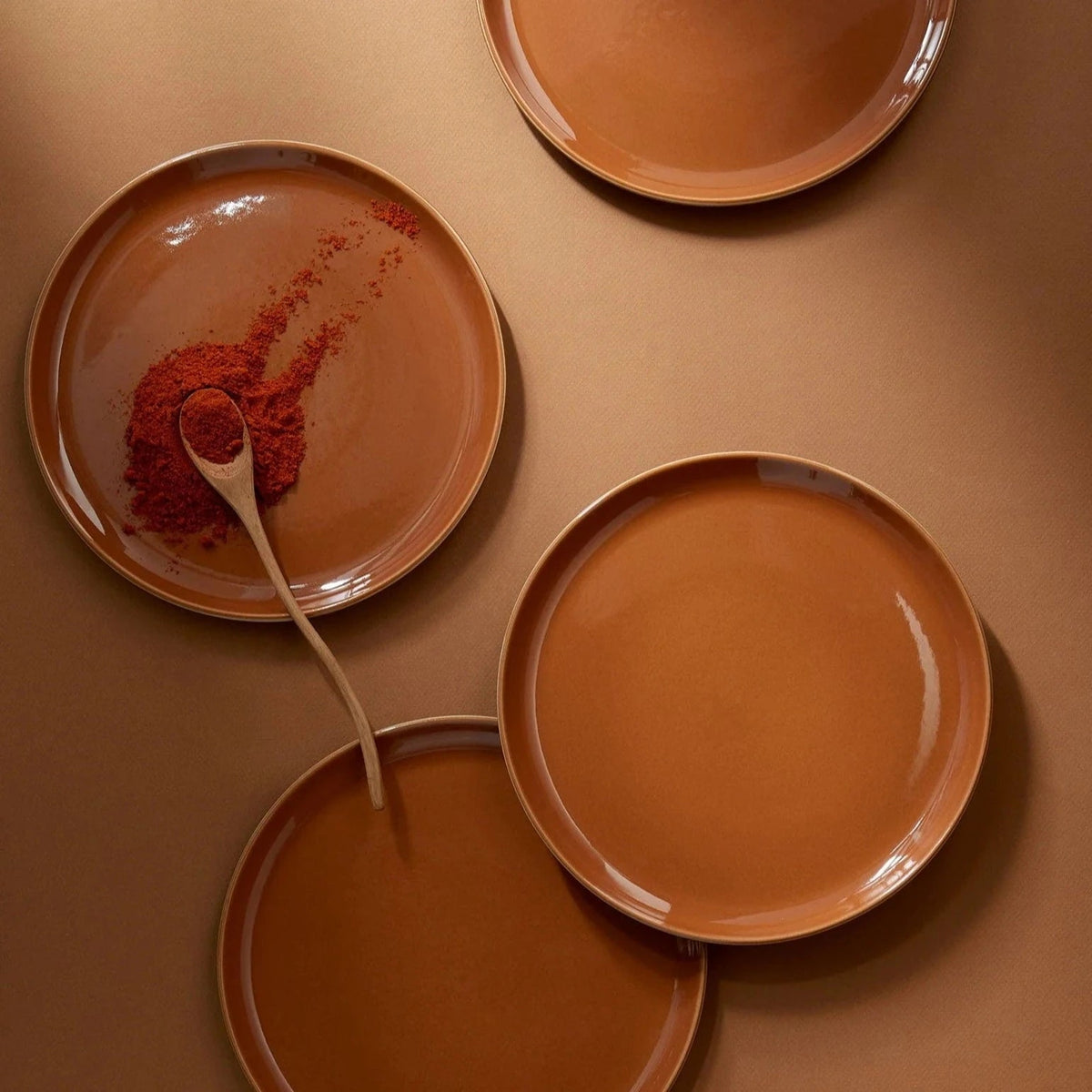 Terracotta dinner plate and bowls with red spice on plate