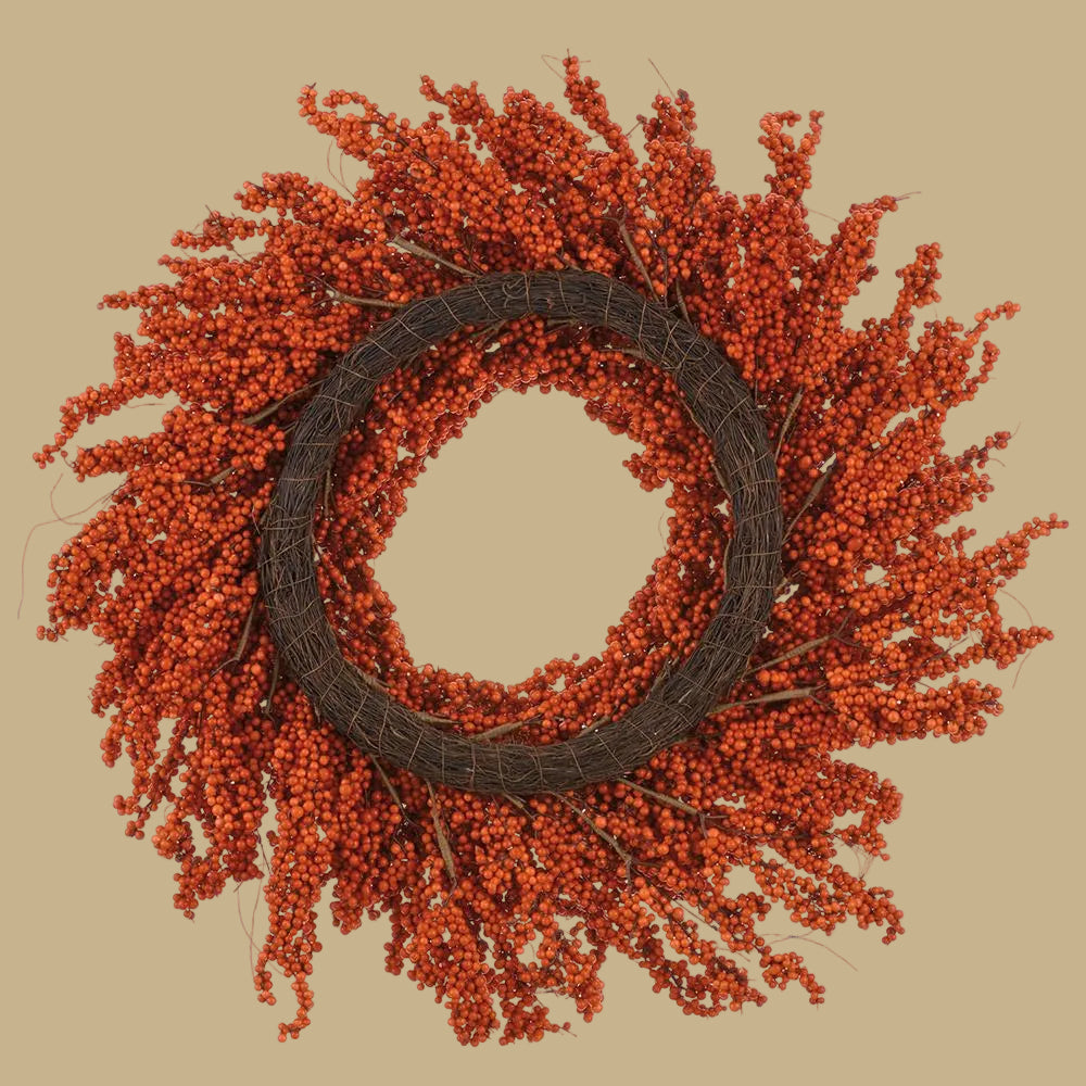 Orange berry wreath on dark woven ring, dense twig-like sprigs around center