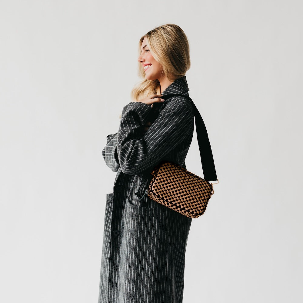 Woven camera crossbody bag with dark checkered pattern and short tassel detail