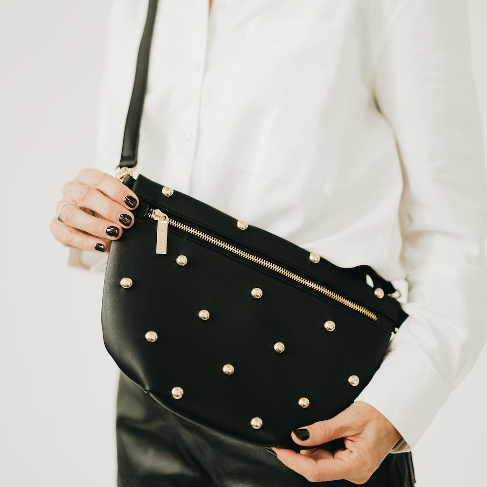 Black faux-leather bum bag with gold studs and front zipper
