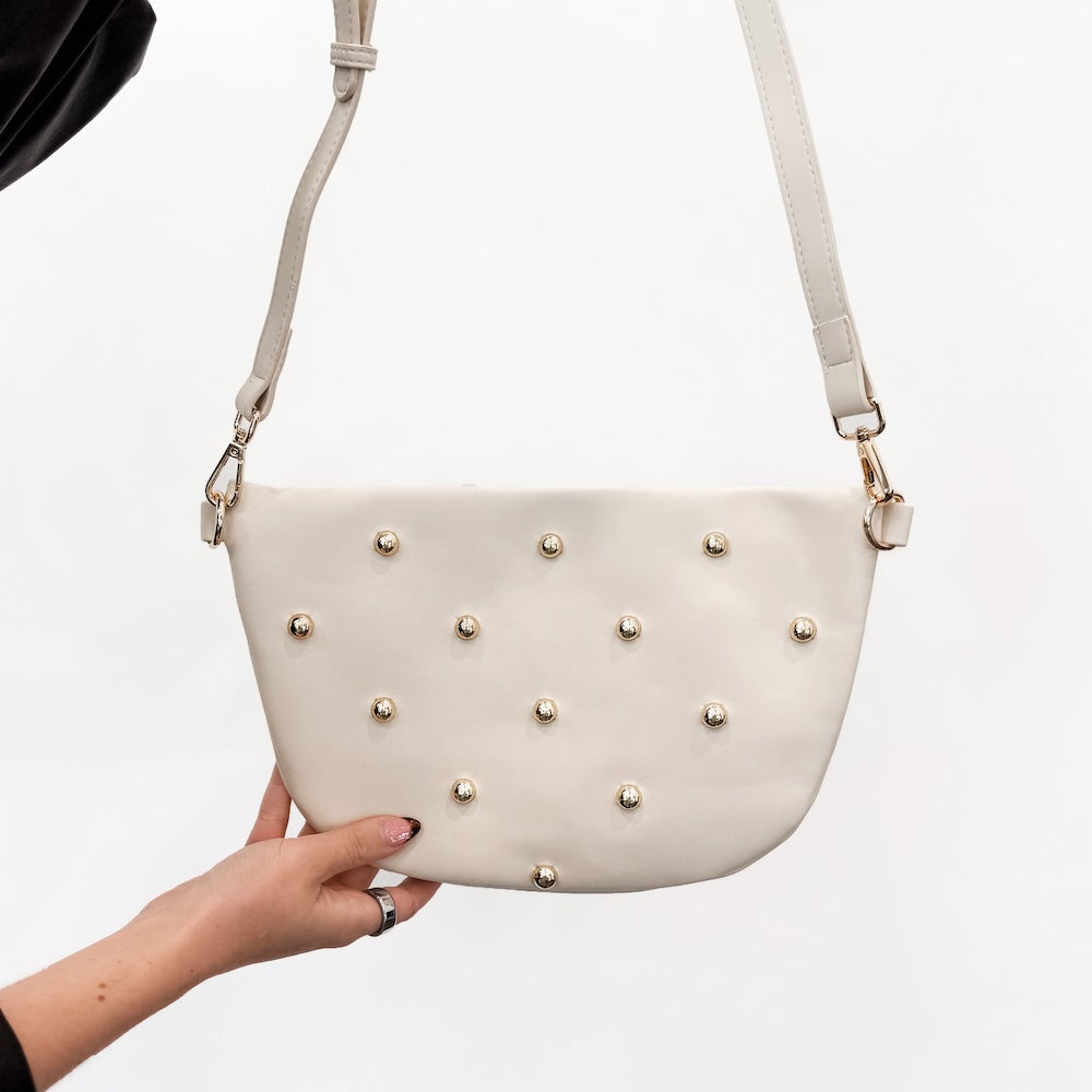 Cream faux-leather crossbody bum bag with gold studded front and shoulder straps