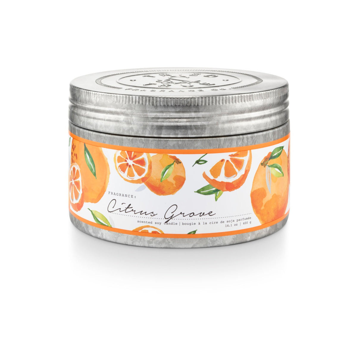 Round soy candle in round metal tin with orange citrus label and silver lid