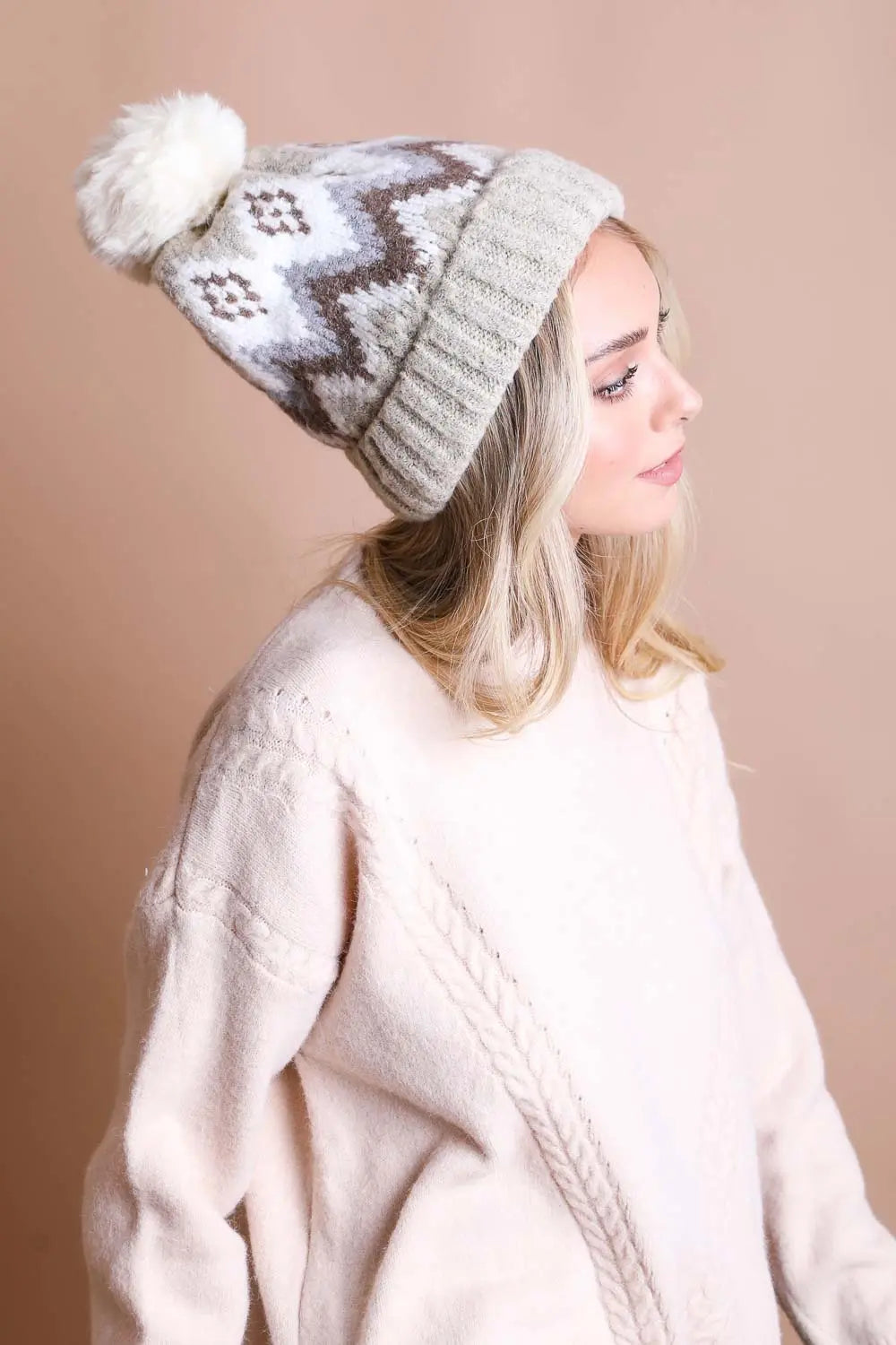 Light gray knit winter beanie with white fair isle pattern and white pom-pom