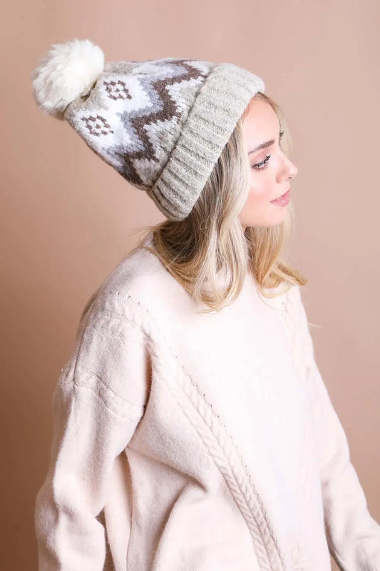 Light gray knit winter beanie with white fair isle pattern and white pom-pom