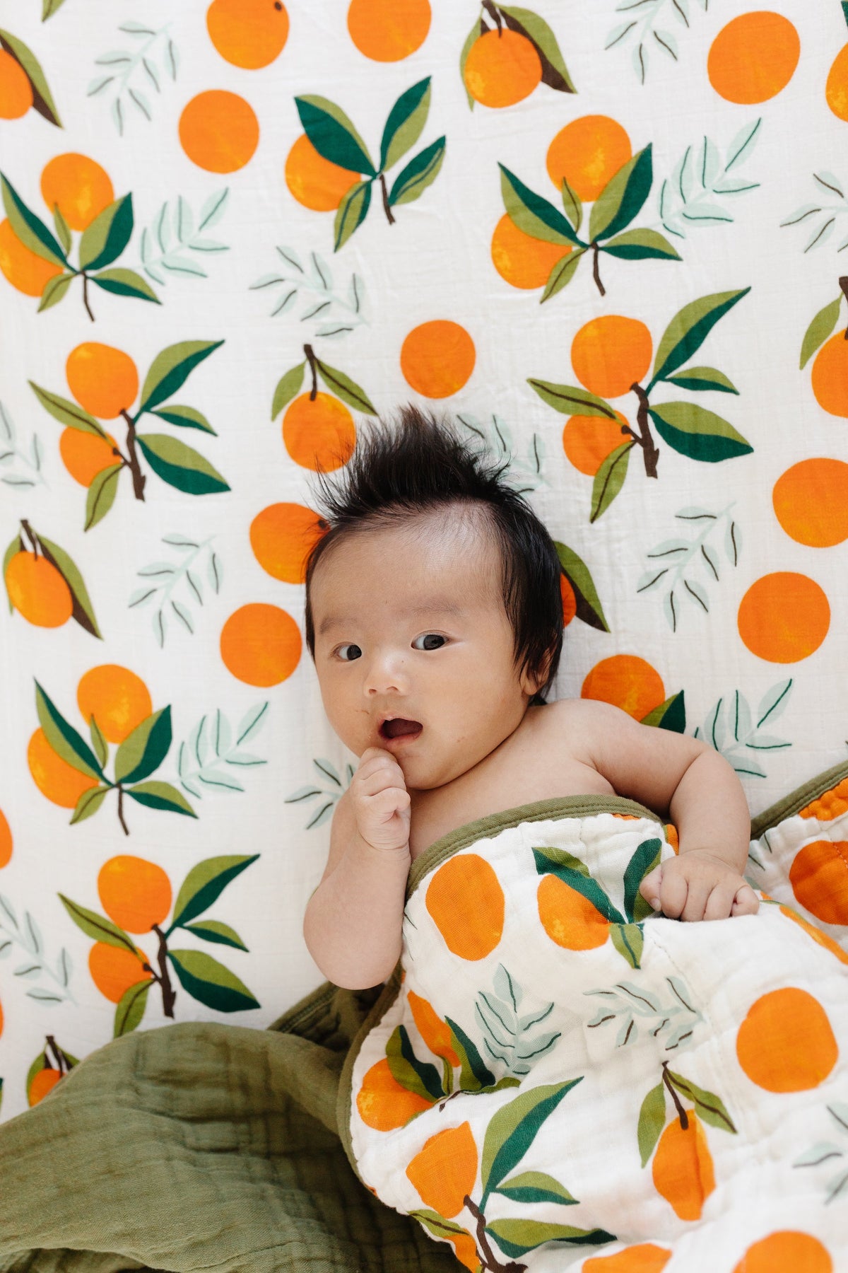 Fresh Clementine quilt with orange fruit and leaf print, white base, green edge border