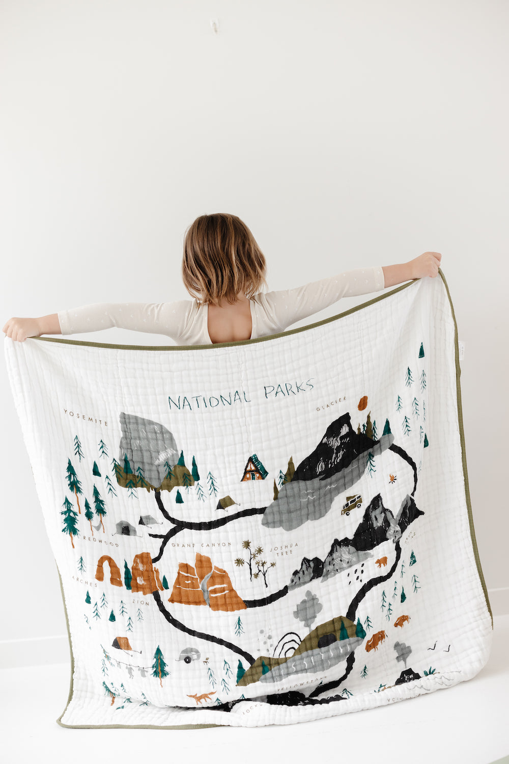 National Parks quilt with illustrated mountain and tree scene on white fabric