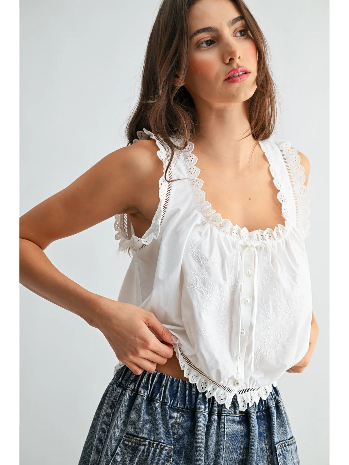 White sleeveless cotton top with lace straps, embroidered front and button closure