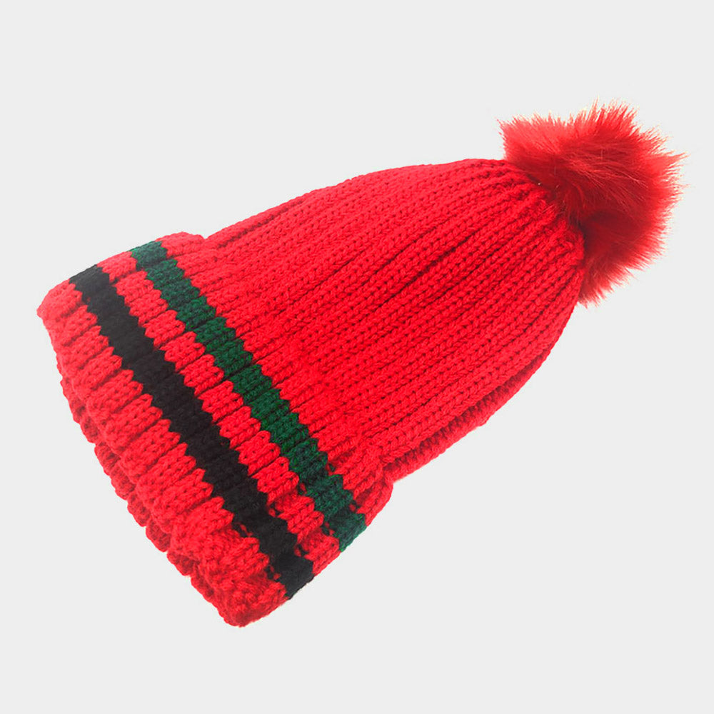 Red knit beanie with black and green stripe panels and red pom-pom