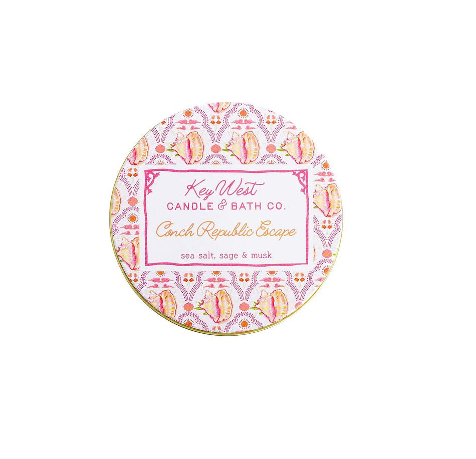 Pink patterned travel tin candle lid with “Key West” label and “Conch Republic Escape” text