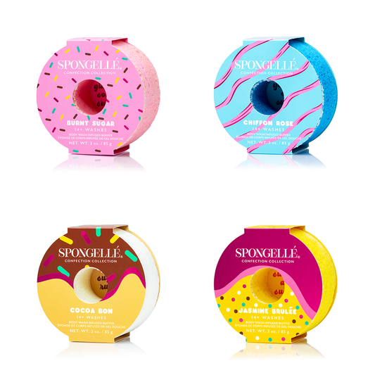 Assorted donut-shaped bath buffers in pink, blue, yellow, and purple.