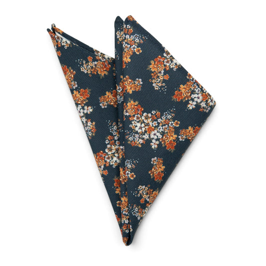Navy pocket square with orange and white floral print, folded triangular