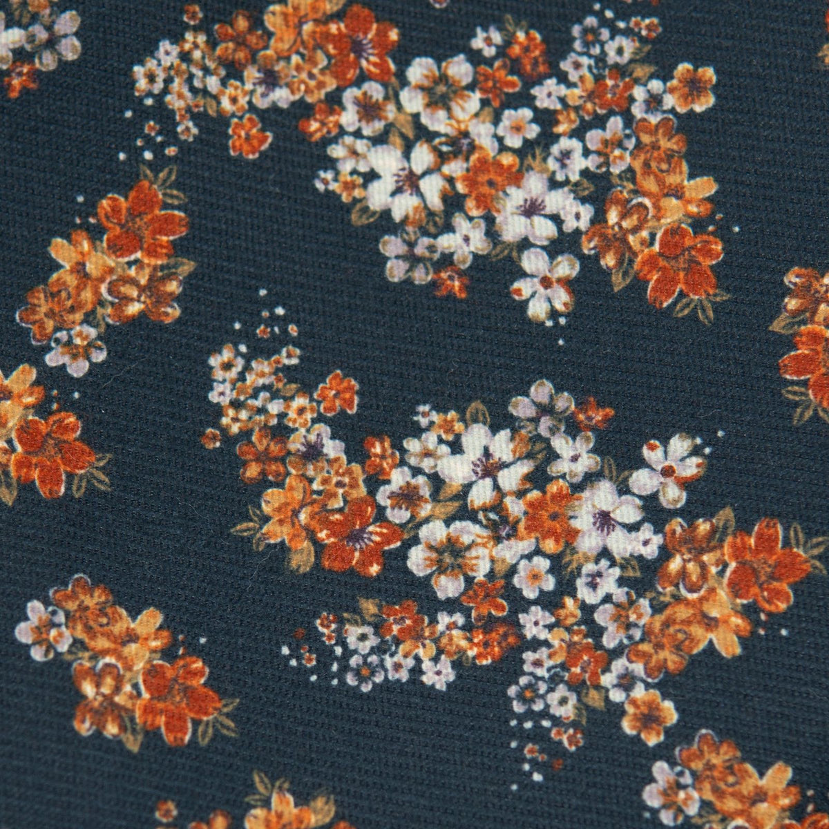 Dark navy fabric with dense orange and cream floral pattern