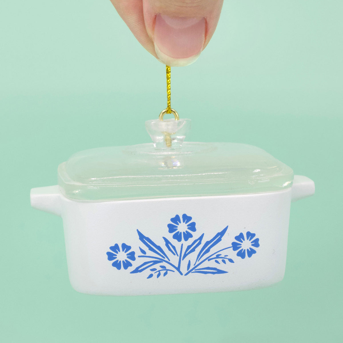 Mini casserole ornament with blue cornflower pattern, clear lid, gold hanging cord