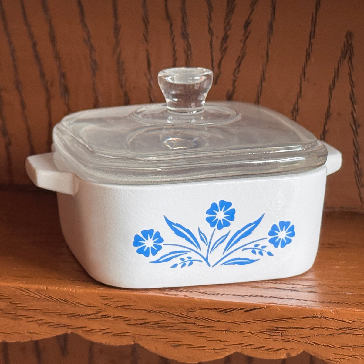 Mini trinket box with clear glass lid and blue cornflower floral design on front