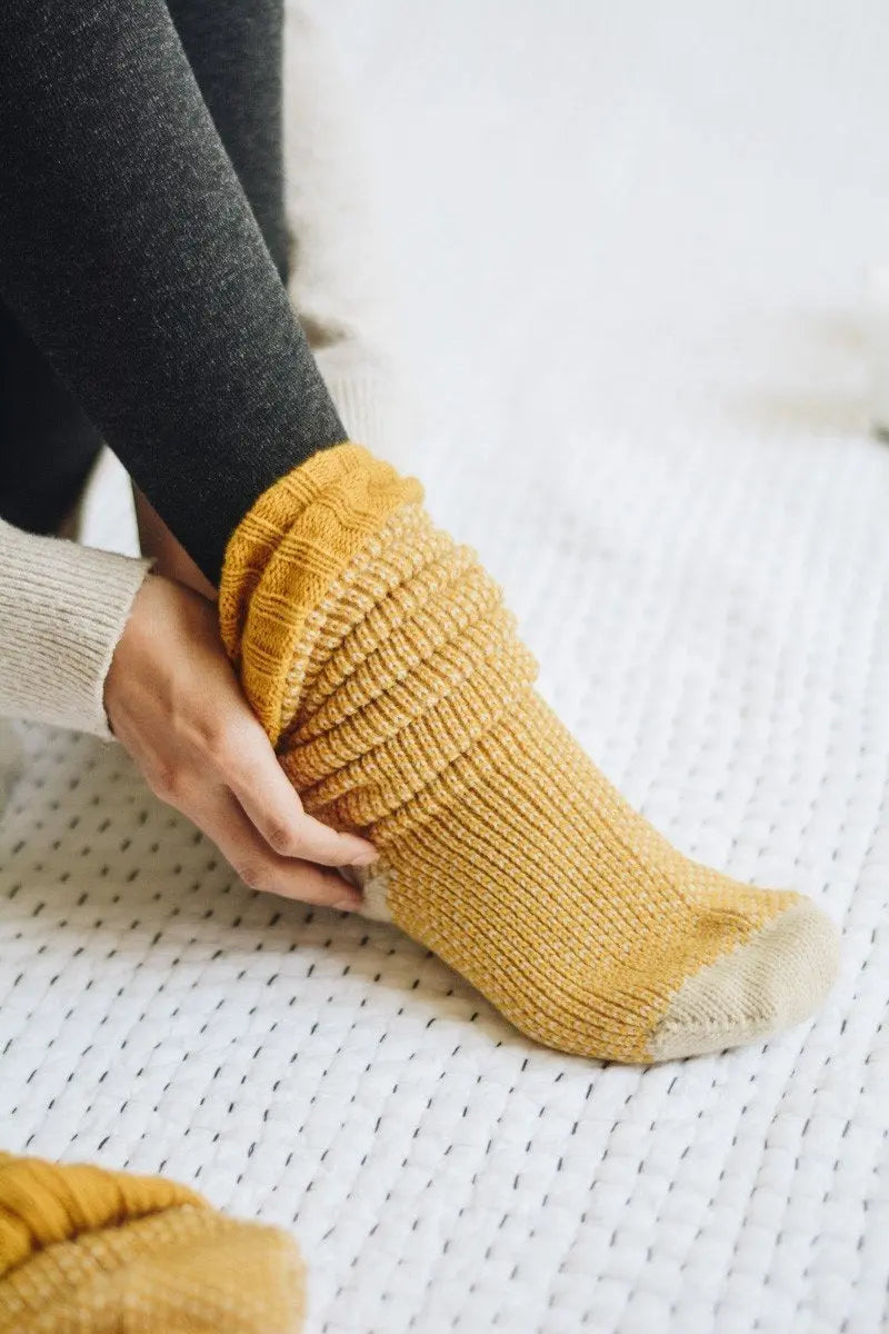 Ribbed knit lounge socks in warm mustard yellow with textured knit and cream toe