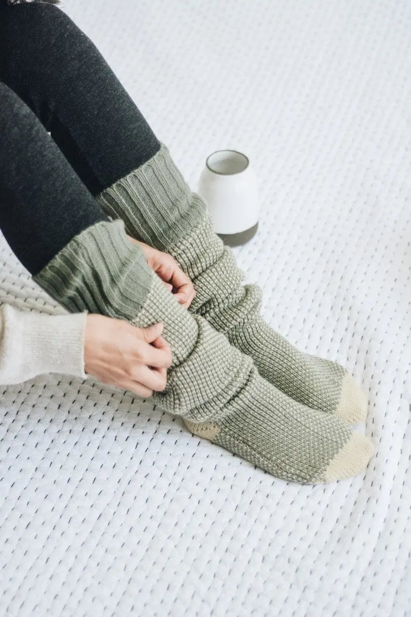 Ribbed knit lounge socks in light sage green with cream toe and ribbed texture