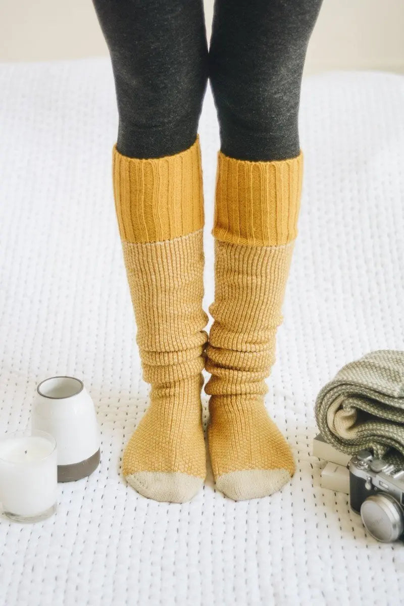 Ribbed knit lounge socks in mustard yellow with thick ribbed shafts and cream sole