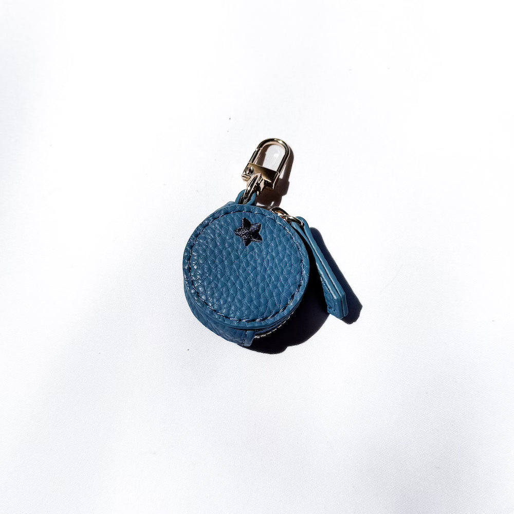 Blueberry-shaped leather keychain charm in blue round design with dark star detail.