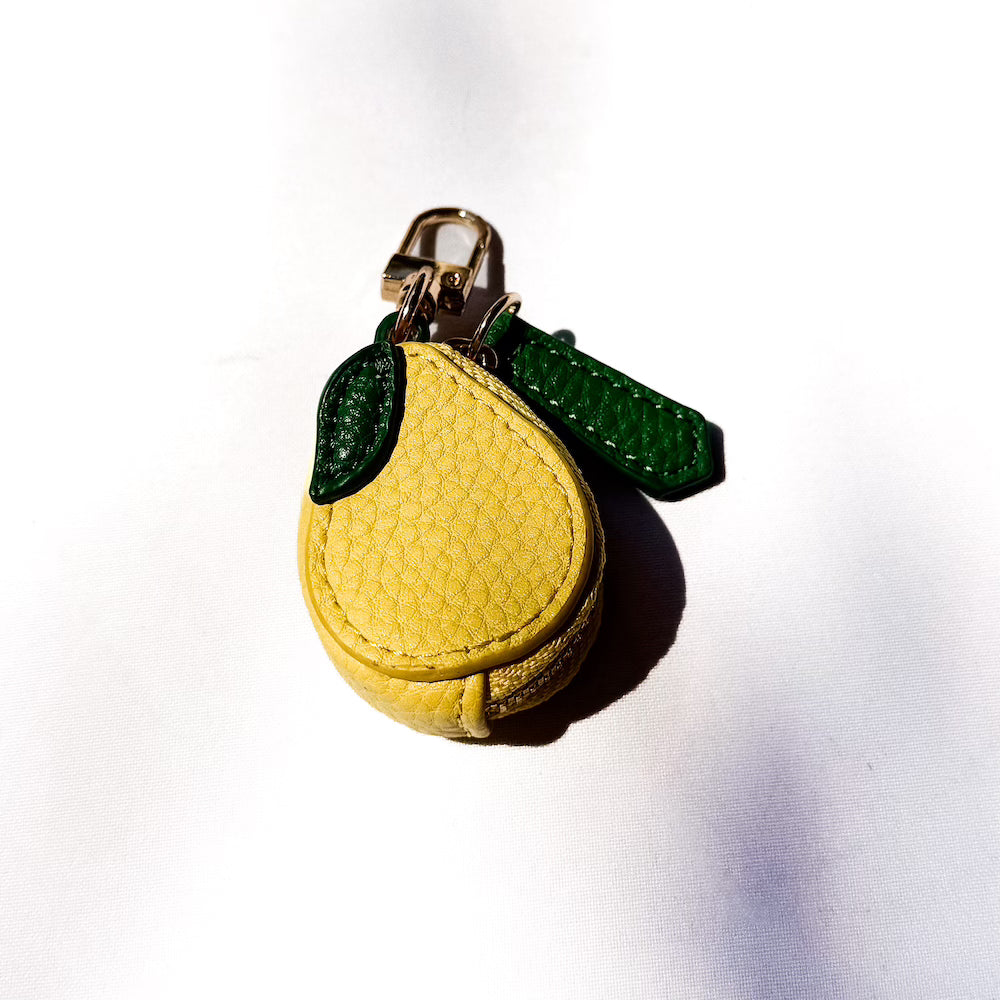 Lemon-shaped fabric keychain charm with metal clasp and green loop