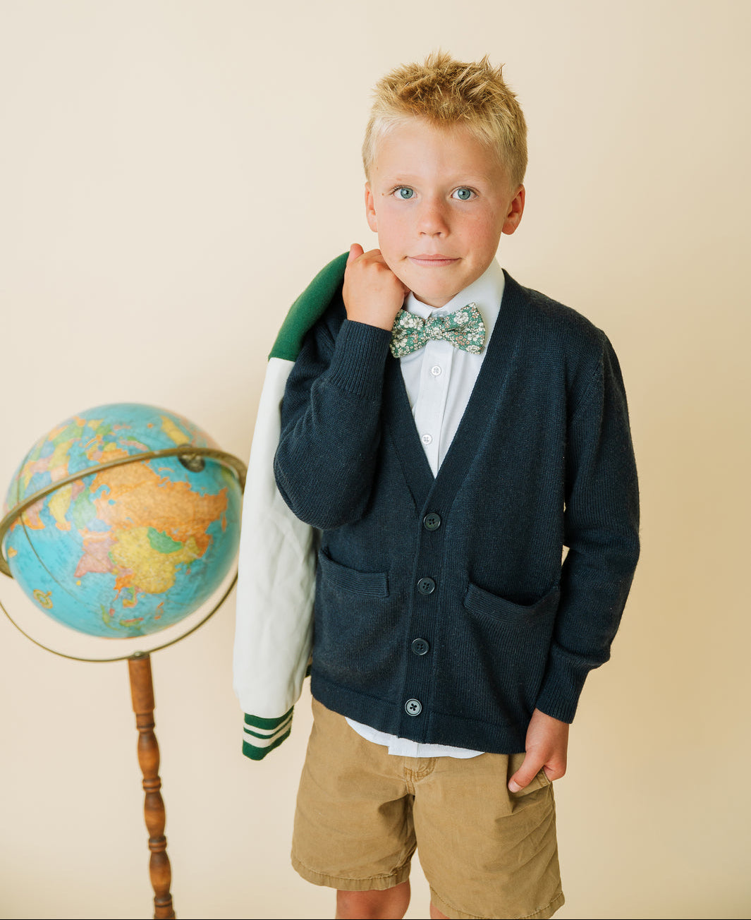 Boys pre-tied bow tie with green floral pattern and white tan flowers